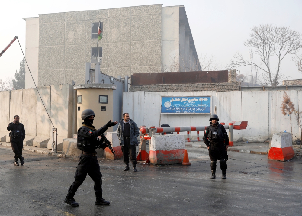  Afghan policemen stand guard outside the government compound after an attack in Kabul, Afghanistan December 25, 2018.REUTERS/Mohammad Ismail	
