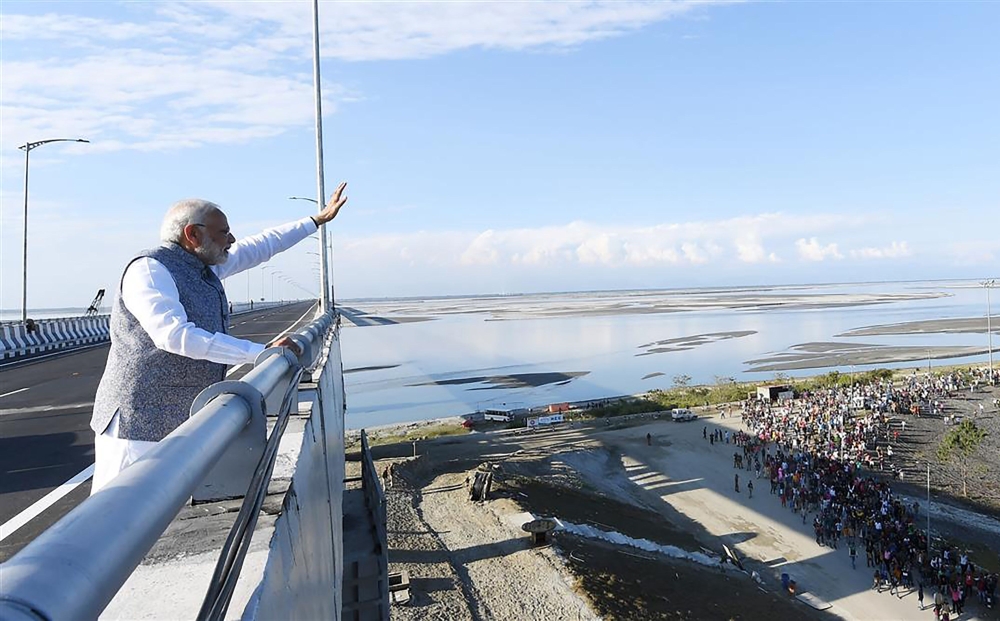 Indian Prime Minister Narendra Modi (C) gestures as he inaugurates India’s longest rail-road bridge at Dibrugarh in Assam on December 25, 2018. (AFP PHOTO / PIB)