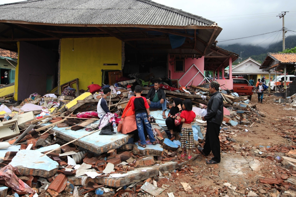 Residents are seen among collapsed buildings following the tsunami waves that hit the coast of Banten and Lampung in South Lampung, Indonesia on December 25, 2018.  Muhammad A.F - Anadolu 