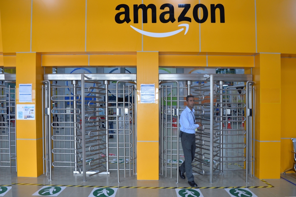 FILE PHOTO: An employee of Amazon India walks out of a security gate at Amazon's newly launched fulfilment centre on the outskirts of Bangalore. AFP / MANJUNATH KIRAN
