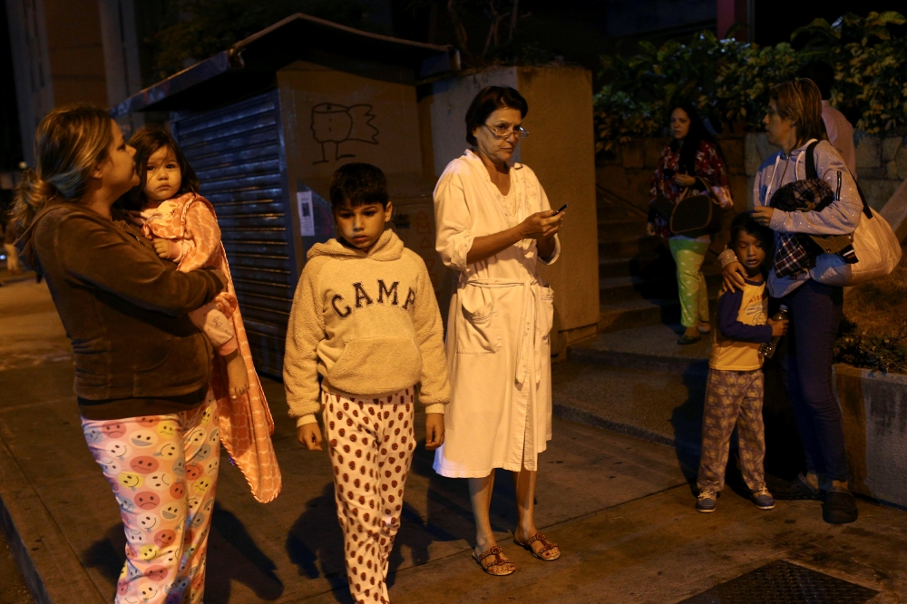 People stand on the street after an earthquake was felt across northern Venezuela, in Caracas, Venezuela December 27, 2018. REUTERS/Manaure Quitero