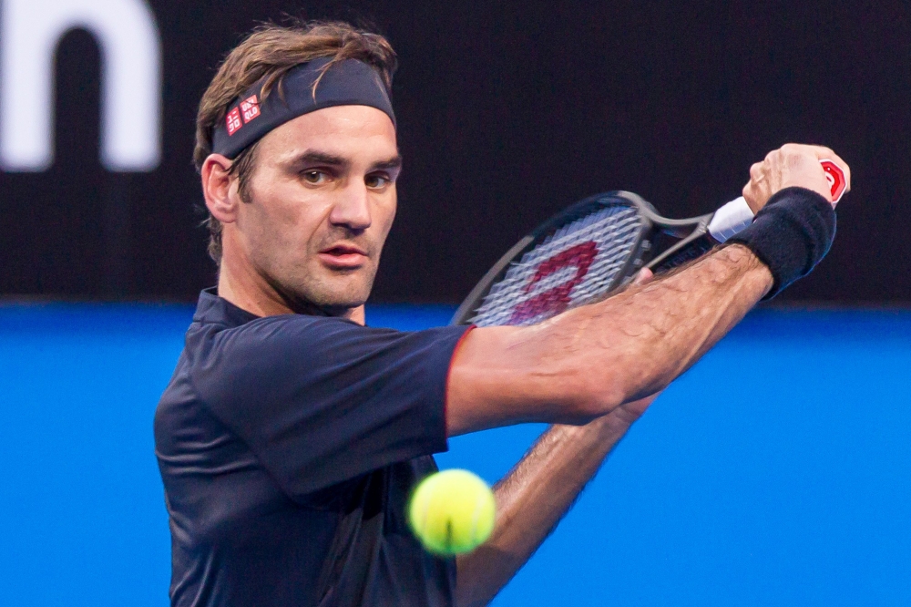 Roger Federer of Switzerland hits a return against Cameron Norrie of Britain during their fourth session men's singles match on day two of the Hopman Cup tennis tournament in Perth on December 30, 2018. AFP / TONY ASHBY