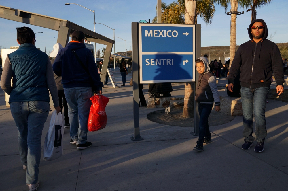  Pedestrians, coming from Mexico, exit the San Ysidro Port of Entry along the US/Mexico border on Saturday, December 29, 2018 in San Ysidro, California. President Donald Trump has threatened to shut down the border if he doesn't get over 5 Billion in fund
