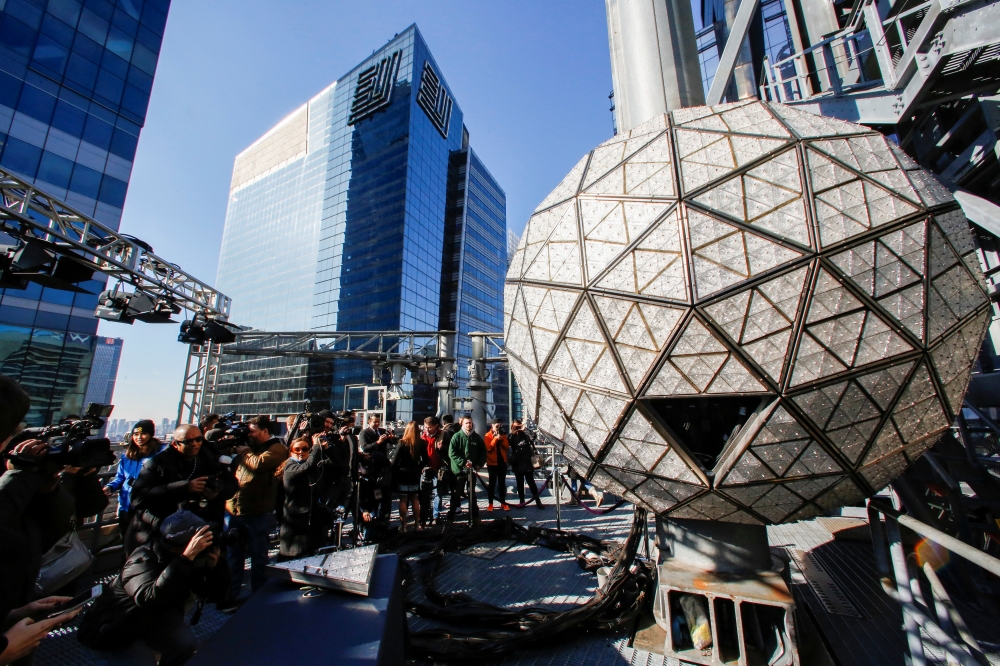 Media try to take a look of the Waterford Crystal triangles on the Times Square New Year's Eve Ball on the roof of One Times Square in the Manhattan borough of New York, U.S., December 27, 2018. REUTERS/Eduardo Munoz