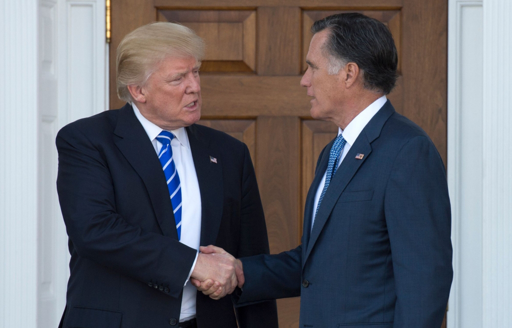 FILE PHOTO: US President-elect Donald Trump shakes hands with Mitt Romney after their meeting at the clubhouse of Trump National Golf Club in Bedminster, New Jersey. January 1, 2019.  AFP / Don EMMERT