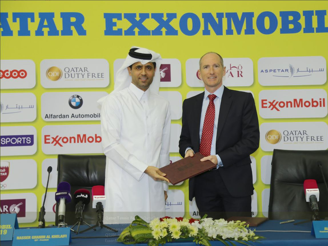 The President of Qatar Tennis, Squash and Badminton Federation (QTSBF) Nasser bin Ghanim Al Khelaifi (left) exchange documents with President and General Manager for ExxonMobil Qatar Alistair Routledge during the sponsorship signing ceremony in Doha yeste