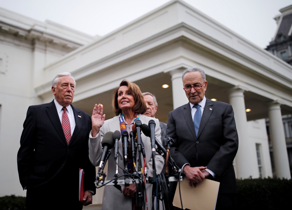 House Democratic leader Nancy Pelosi (D-CA) speaks to reporters with Senate Democratic leader Chuck Schumer (D-NY), Rep. Steny Hoyer (D-MD) and Sen.   REUTERS/Carlos Barria
