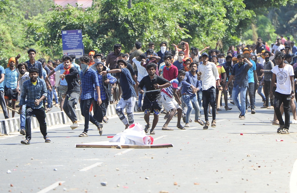 Indian protesters throw stones at police during a demonstration over two women entering the Sabarimala Ayyapa temple, in Palakkad in southern Kerala state on January 3, 2019. (AFP)