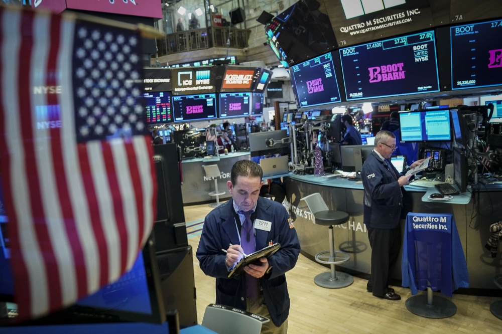 Traders and financial professionals work on the floor of the New York Stock Exchange (NYSE) ahead of the opening bell, January 4, 2019 in New York City. (Drew Angerer/Getty Images/AFP)