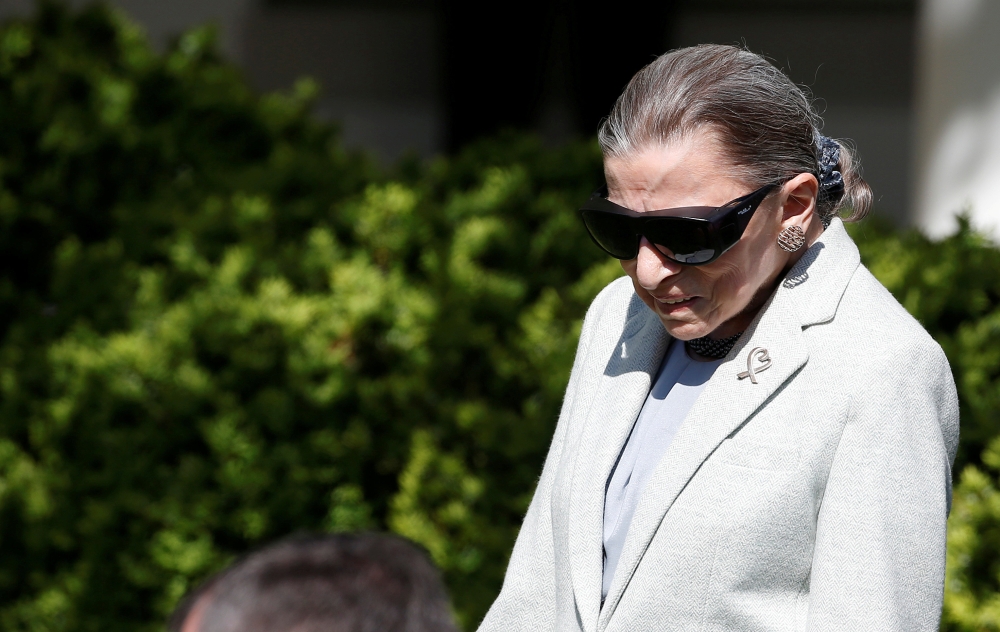 FILE PHOTO: Associate Supreme Court Justice Ruth Bader Ginsburg arrives for the swearing in ceremony of Judge Neil Gorsuch in the Rose Garden of the White House in Washington, U.S., April 10, 2017.Joshua Roberts \ REUTERS