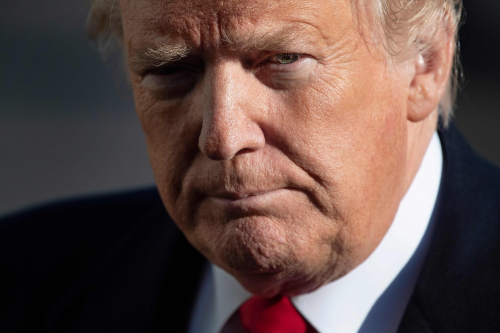 US President Donald Trump speaks as he arrives at the White House in Washington, DC, on January 6, 2019, after meetings at Camp David.  AFP / Jim WATSON
