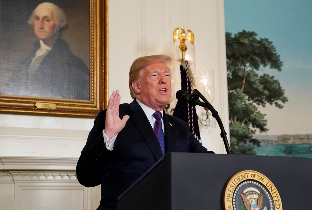 FILE PHOTO: U.S. President Donald Trump announces military strikes on Syria while delivering a statement from the White House in Washington, U.S., April 13, 2018. REUTERS/Yuri Gripas/File Photo