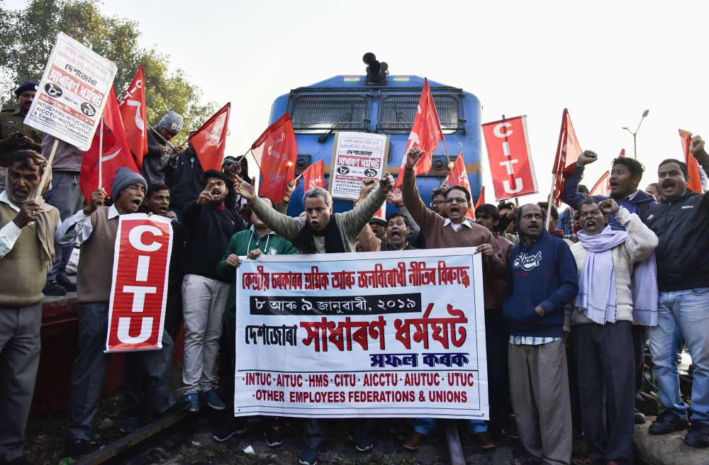 Indian activists from the Centre of Indian Trade Unions (CITU), which is politically aligned with the Communist Party of India (Marxist), block trains at Guwahati Railway Station during a nationwide strike in Guwahati in India's eastern Assam state on Jan