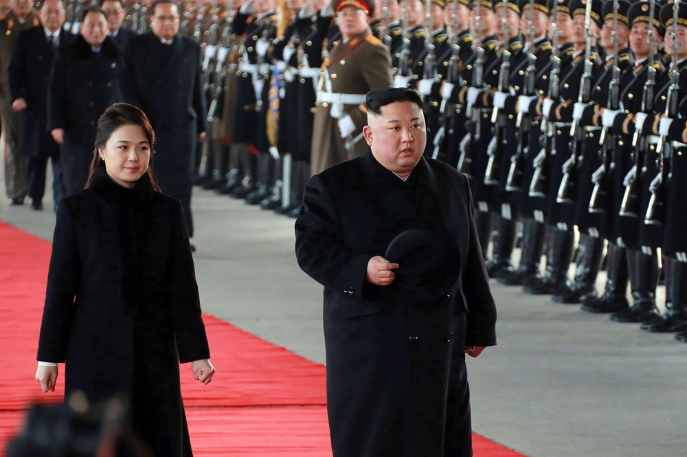 North Korean leader Kim Jong Un (R) and his wife Ri Sol Ju leaving Pyongyang Station to visit China. 