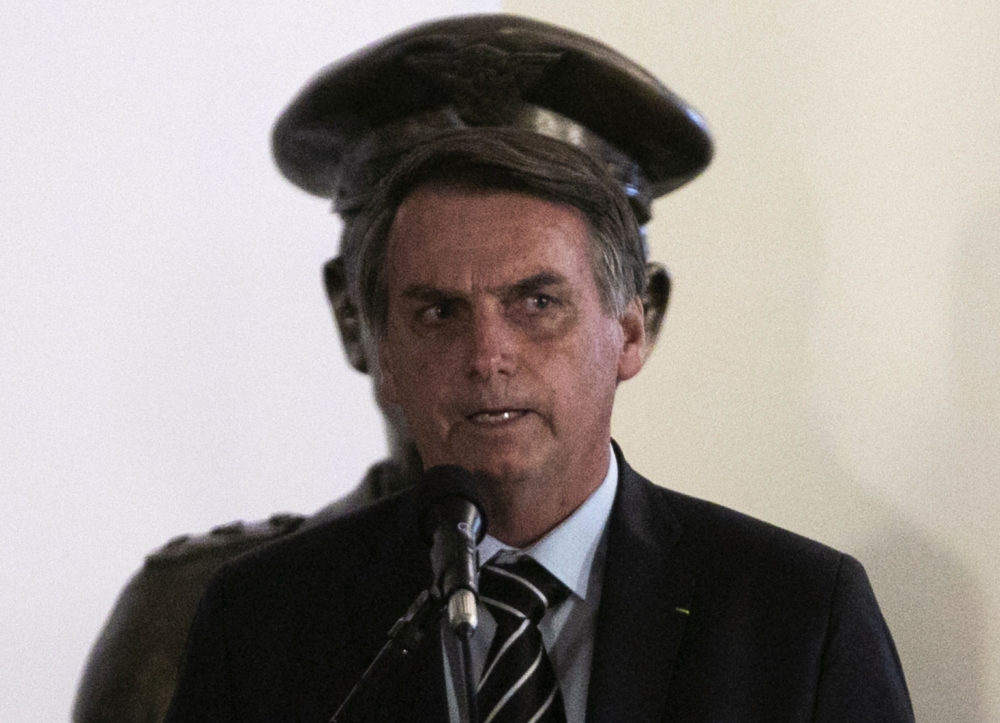 Brazil's President Jair Bolsonaro speaks at the handover of his new Defence Minister Fernando Azevedo e Silva in Brasilia on January 2, 2018. / AFP / Sergio LIMA
