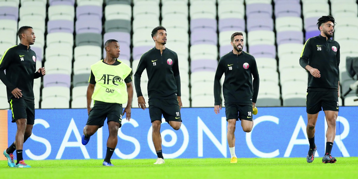 Qatari players in action during a practice session on the eve of their opening match of the AFC Asian Cup against Lebanon in Al Ain, UAE, today. 
