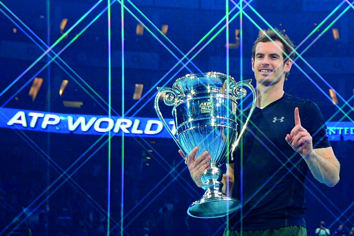 In this file photo taken on November 20, 2016 Britain's Andy Murray poses holding the ATP World Number One trophy after winning the men's singles final against Serbia's Novak Djokovic on the eighth and final day of the ATP World Tour Finals tennis tournam
