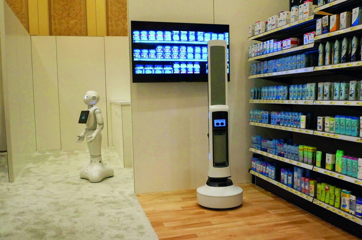 Pepper of SoftBank Robotics (L) and Tally of Simbe Robotics (R) are teaming up to work with retailers: Pepper interacts with customers while Tally scans the shelves to monitor inventory levels in this demo from SoftBank at the Consumer Electronics Show in