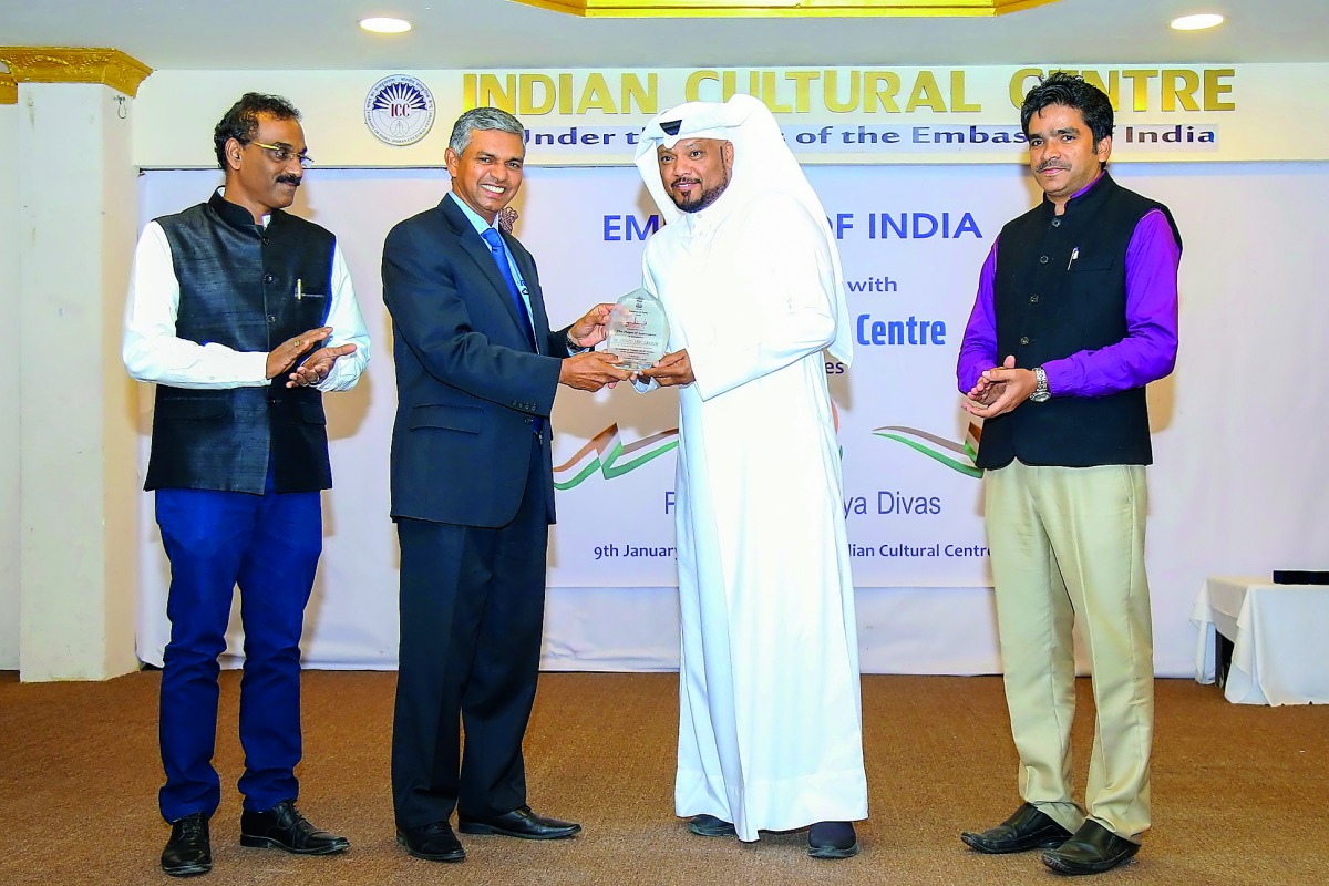 Indian Ambassador P Kumaran presenting a plaque of appreciation to Qatar-based singer Ahmed Abdulrahim.