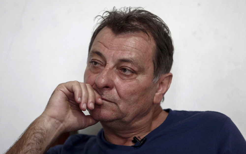 In this file photo taken on October 20, 2017 Italian ultra-leftist militant Cesare Battisti gestures during an interview with AFP in Cananeia, Sao Paulo state, Brazil. / AFP / Miguel SCHINCARIOL 