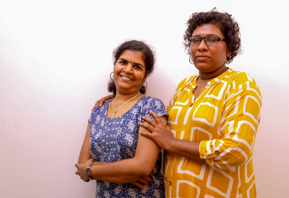 In this photo taken on January 11, 2019, Bindu Ammini (R) and Kanakadurga (L), the two Indian women who entered the Sabarimala Ayyapa temple, pose for photographs during an interview with the media in Kochi in the southern state of Kerala. / AFP / STR /