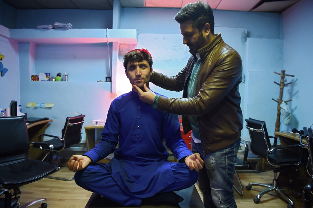 Abdul Salam Maftoon poses for a picture at the Kaboora Production studio in Kabul on January 13, 2019. AFP/Wakil Kohsar