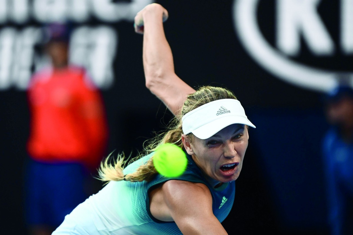 Denmark's Caroline Wozniacki hits a return against Belgium's Alison Van Uytvanck during their women's singles match on day one of the Australian Open tennis tournament in Melbourne on January 14, 2019. AFP / Jewel Samad 