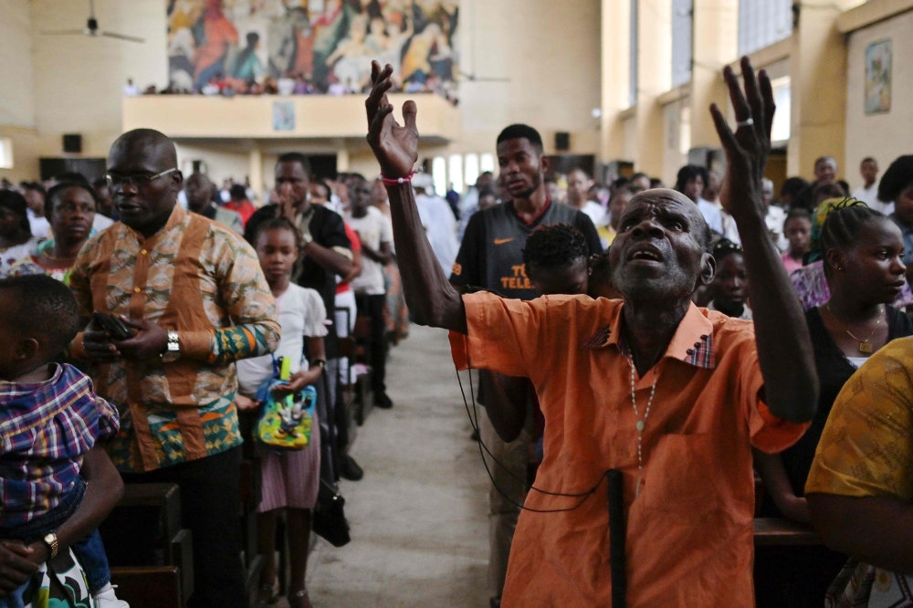 Catholic worshipers attend a Sunday mass at the Saint Joseph church on January 13, 2019, in the capital Kinshasa, in the Democratic Republic of the Congo. AFP / Tony Karumba 
