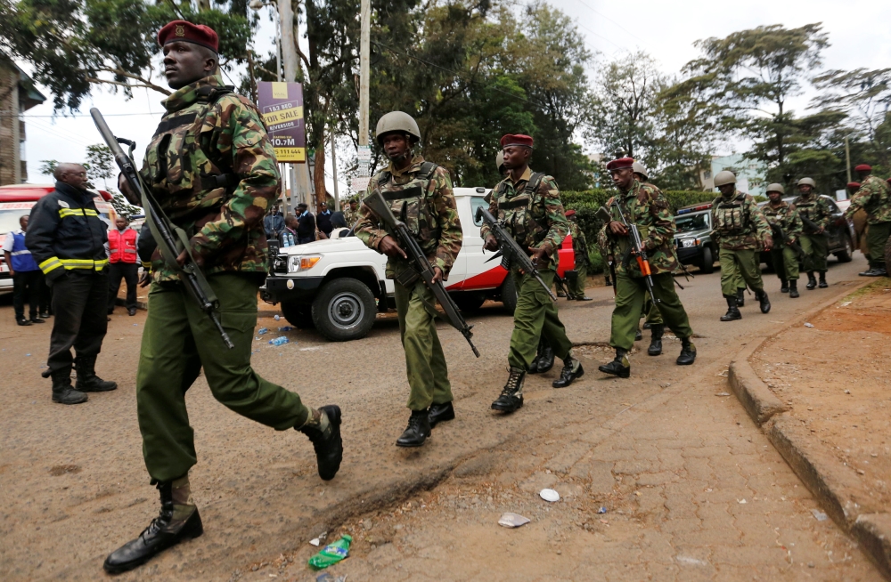 Kenyan policemen walk from the scene where explosions and gunshots were heard at the Dusit hotel compound in Nairobi, Kenya, January 16, 2019. REUTERS/Thomas Mukoya