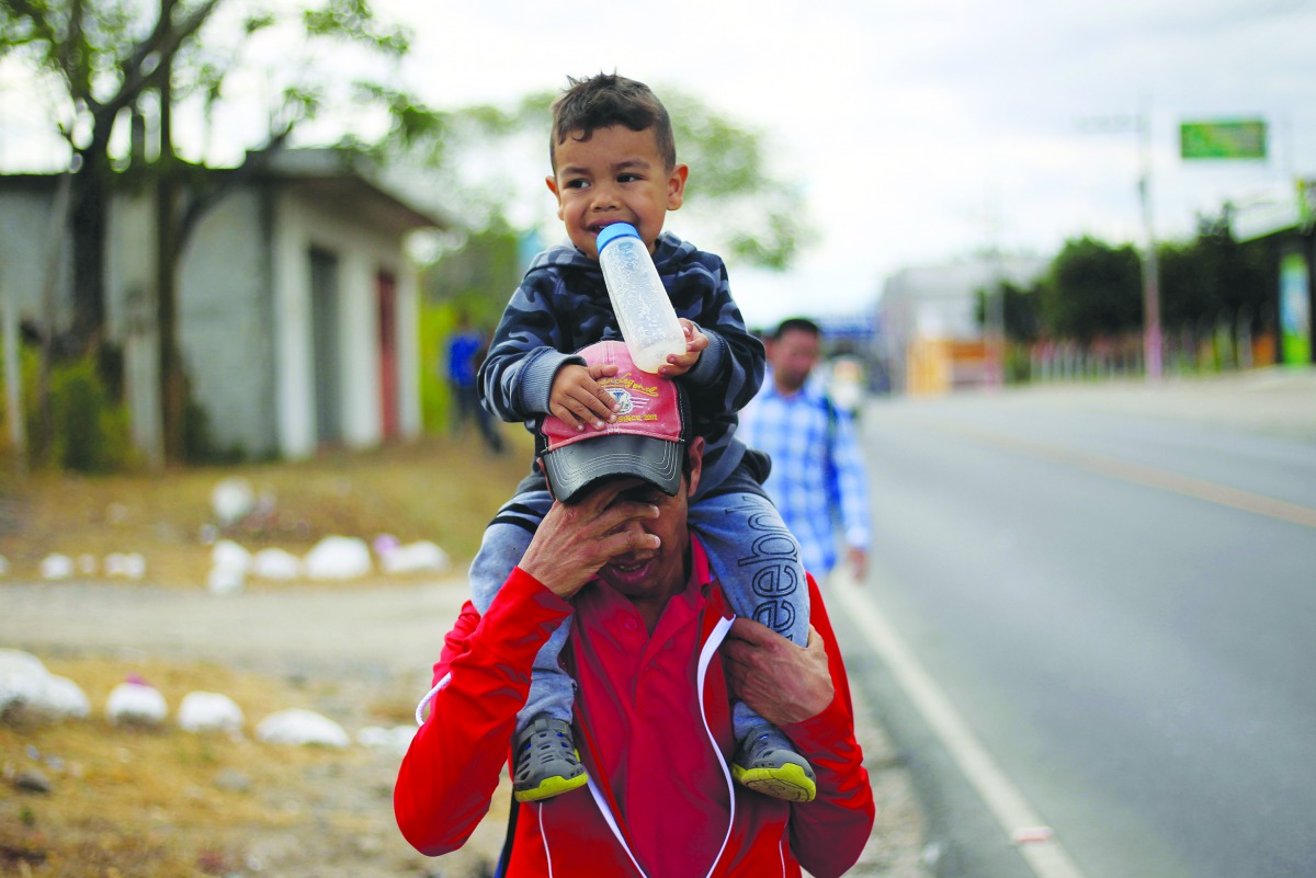 Migrants from Honduras, part of a new caravan from Central America trying to reach the United States, walk along a road in Chiquimula, Guatemala January 16, 2019. Reuters/Jorge Cabrera