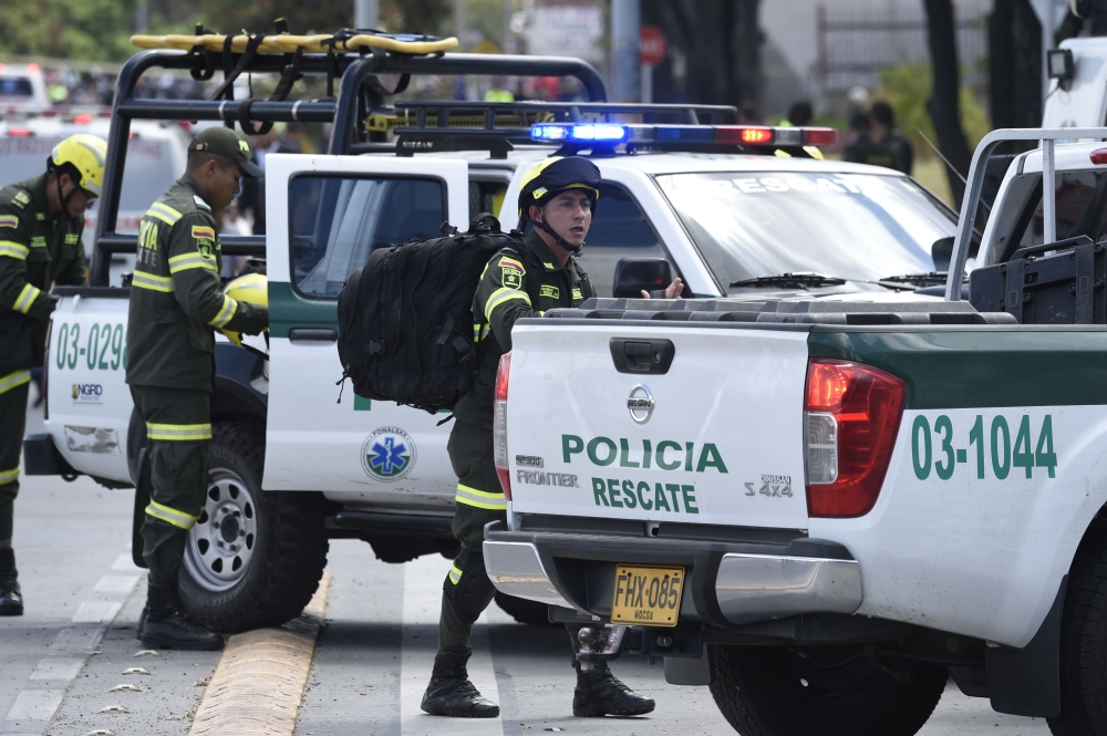 Security forces work at the site of an apparent car bomb attack on a police cadet training school in Bogota, that left at least four people dead and 10 injured on January 17, 2019.  AFP / Juan Barreto