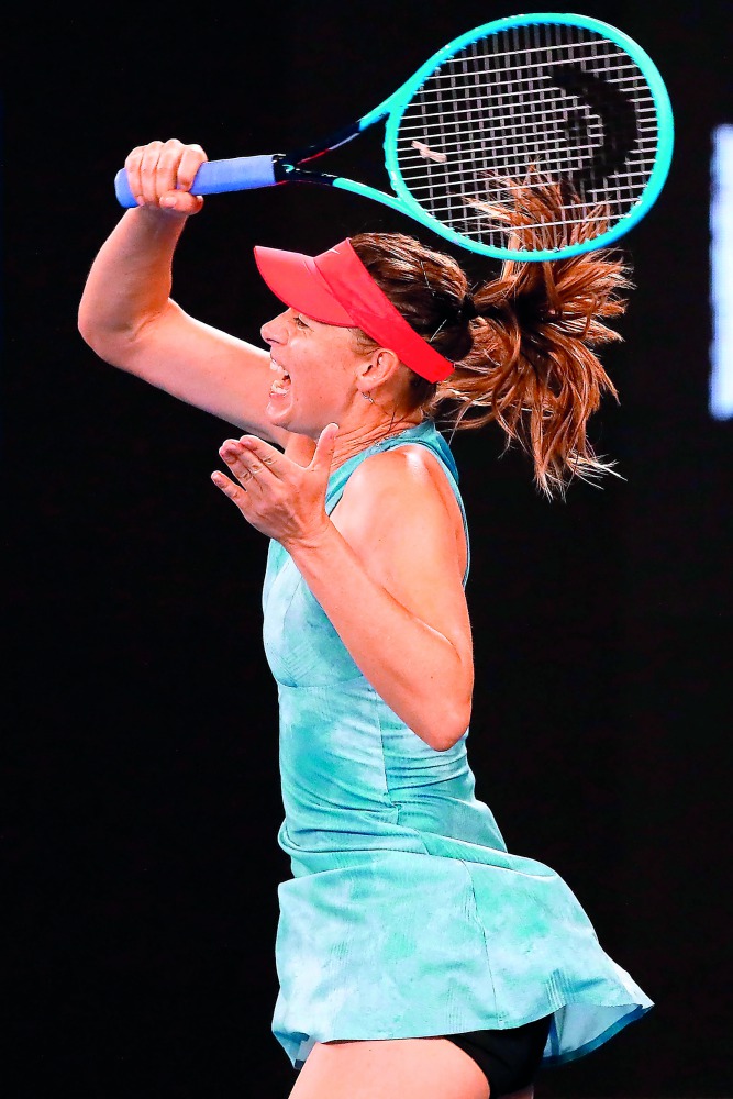 Russia's Maria Sharapova hits a return against Denmark's Caroline Wozniacki during their women's singles match on day five of the Australian Open tennis tournament in Melbourne on January 18, 2019.  AFP / David Gray 