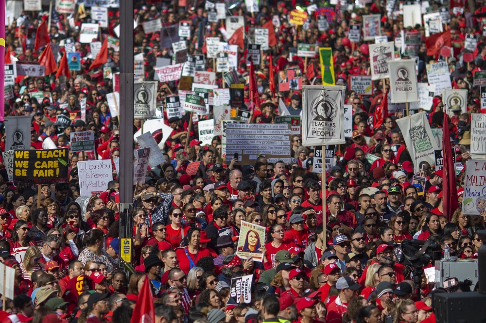 Striking teachers and supporters rally outside City Hall as negotiations resume on January 18, 2019 in Los Angeles, California. David McNew/Getty Images/AFP