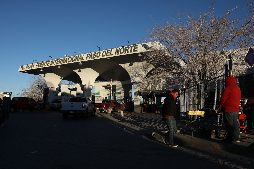 People walk near the entrance to the Paso Del Norte Port of Entry which is a crossing point to enter the United States from Mexico on January 19, 2019, in Ciudad Juarez, Mexico. Joe Raedle/Getty Images/AFP