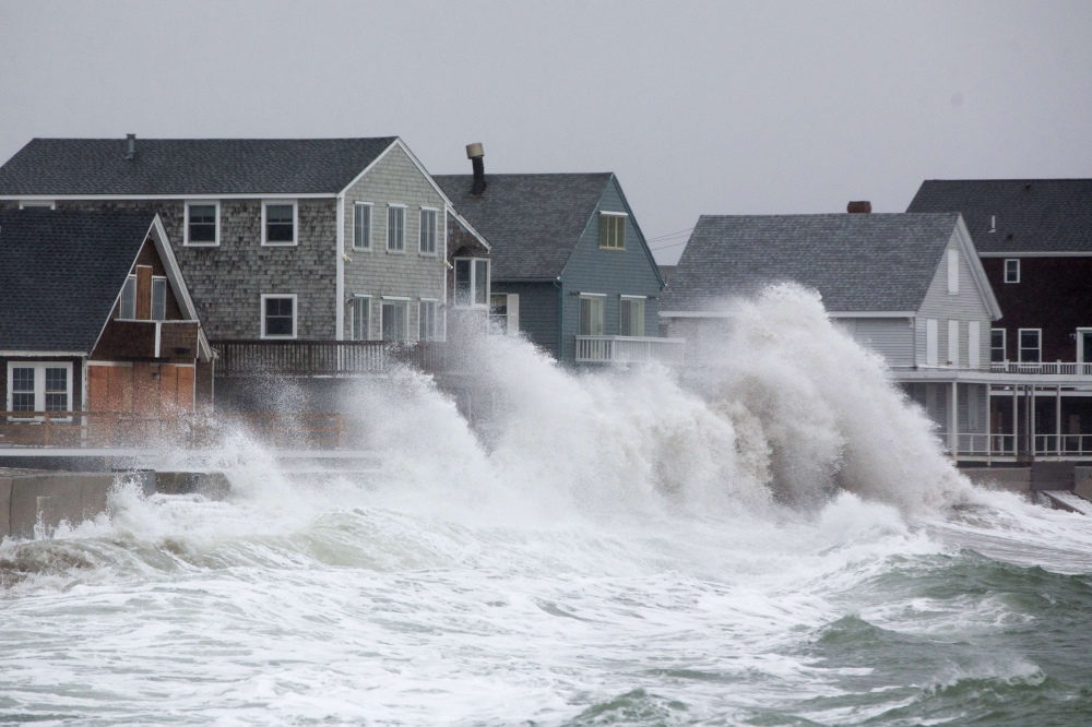 Waves crash over homes on Lighthouse Road during a winter storm that brought snow, sleet and rain to the area on January 20, 2019 in Scituate, Massachusetts. Icy conditions are predicted for much of Massachusetts. (Scott Eisen/Getty Images/AFP)