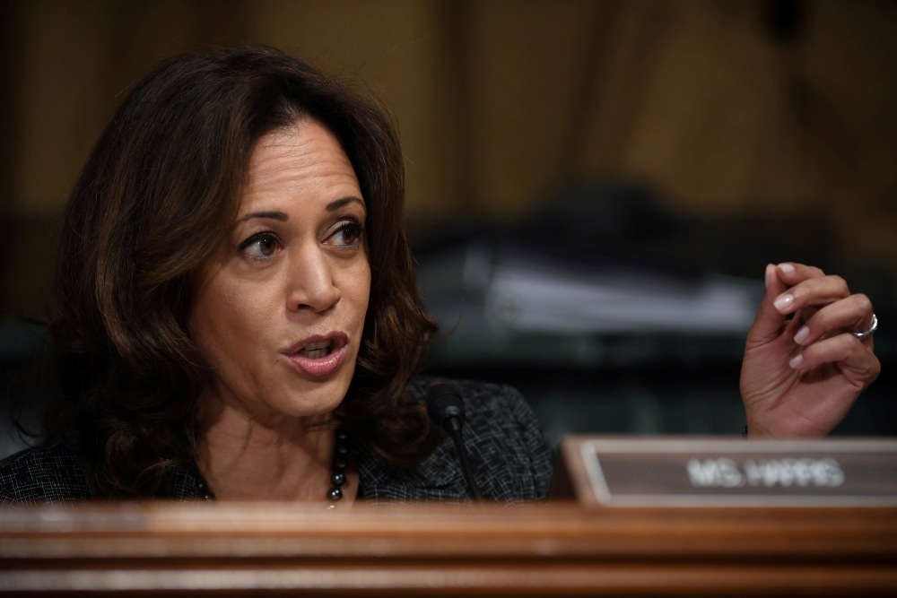FILE PHOTO: Sen. Kamala Harris, D-CA, talks to Christine Blasey Ford, testifying before the U.S. Senate Judiciary Committee on Capitol Hill in Washington, U.S., September 27, 2018. Saul Loeb/Pool via REUTERS/File Photo