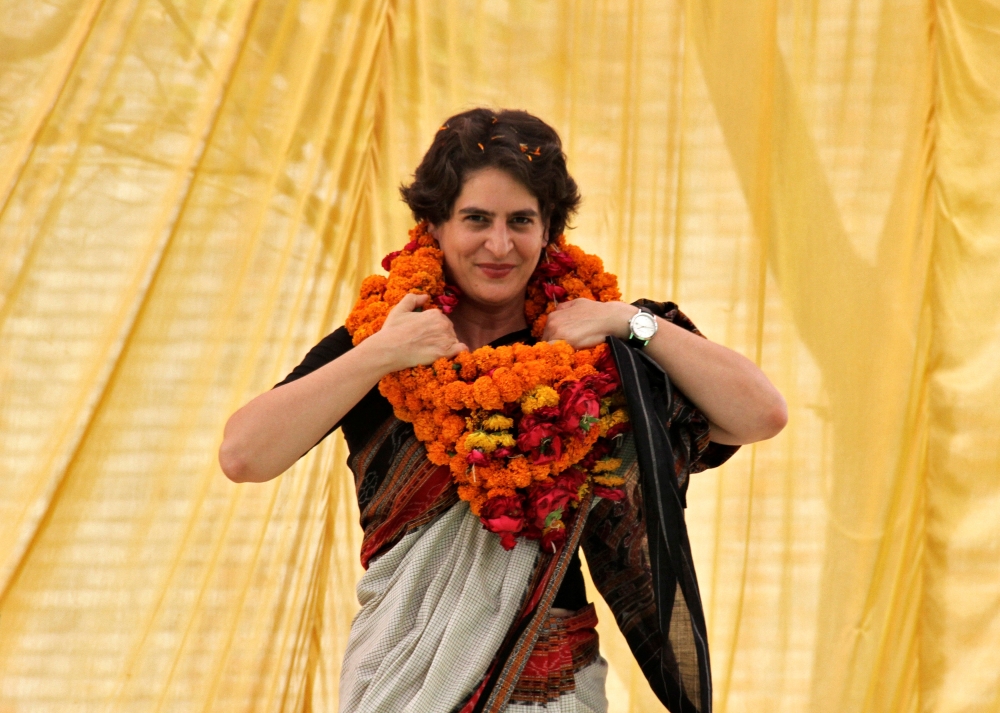 File photo of Priyanka Gandhi Vadra, daughter of India's ruling Congress party chief Sonia Gandhi, adjusts her flower garlands as she campaigns for her mother during an election meeting at Rae Bareli in the northern Indian state of Uttar Pradesh April 22,