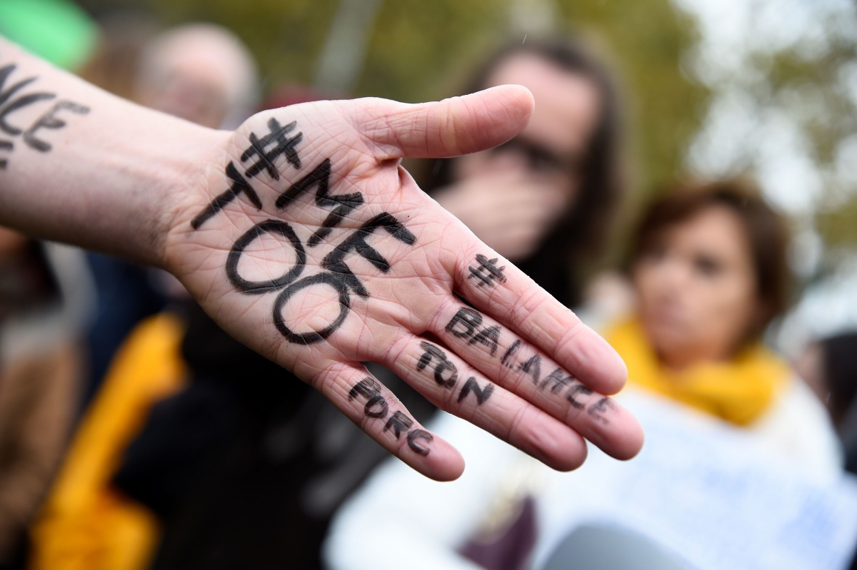 Me too on the hand of a protester during a Paris gathering on October 29, 2017. AFP/Bertrand Guay