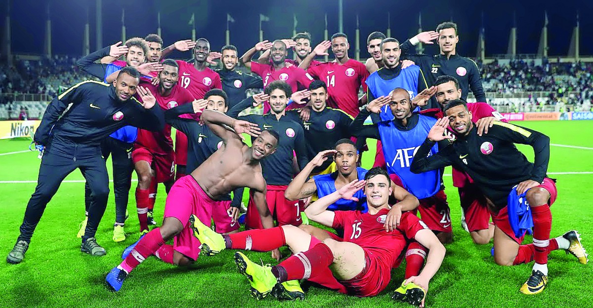 Qatari players celebrate after defeating Iraq 1-0 in AFC Asian Cup UAE 2019 Round of 16 match at the Al Nahyan Stadium in Abu Dhabi on Tuesday.
