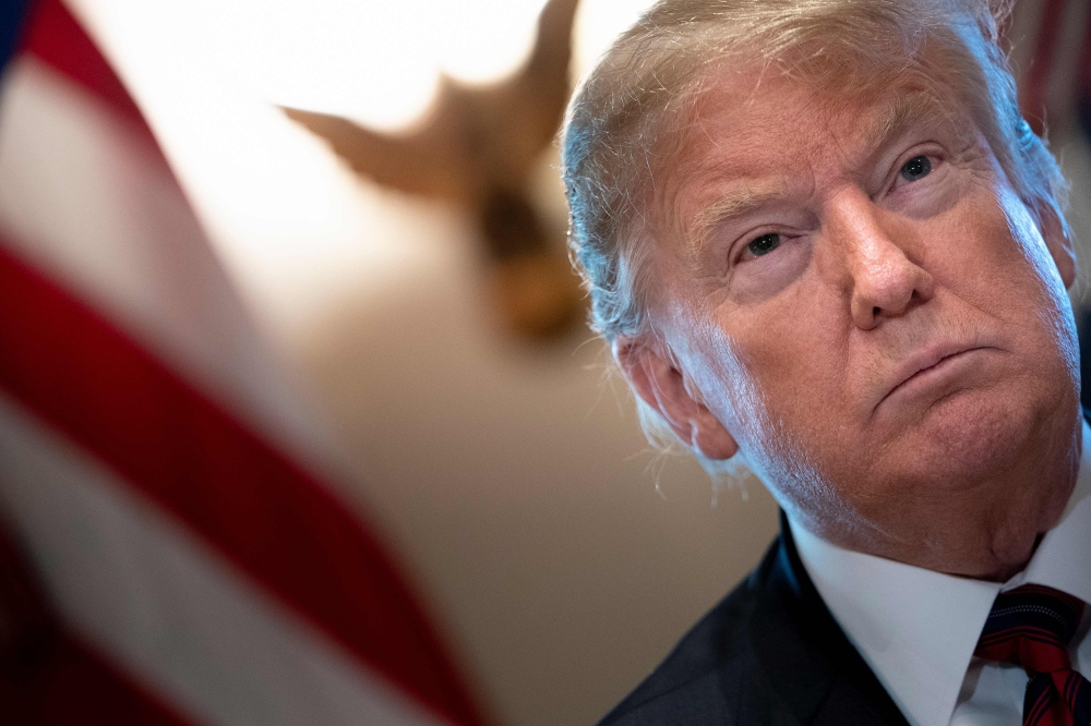 (FILES) In this file photo taken on January 11, 2019, US President Donald Trump listens during a meeting on border security in the Cabinet Room of the White House in Washington, DC. AFP / Brendan Smialowski