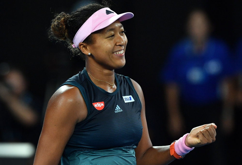 Japan's Naomi Osaka celebrates her victory against Czech Republic's Karolina Pliskova during their women's singles semi-final match on day 11 of the Australian Open tennis tournament in Melbourne on January 24, 2019. AFP / Greg Wood 