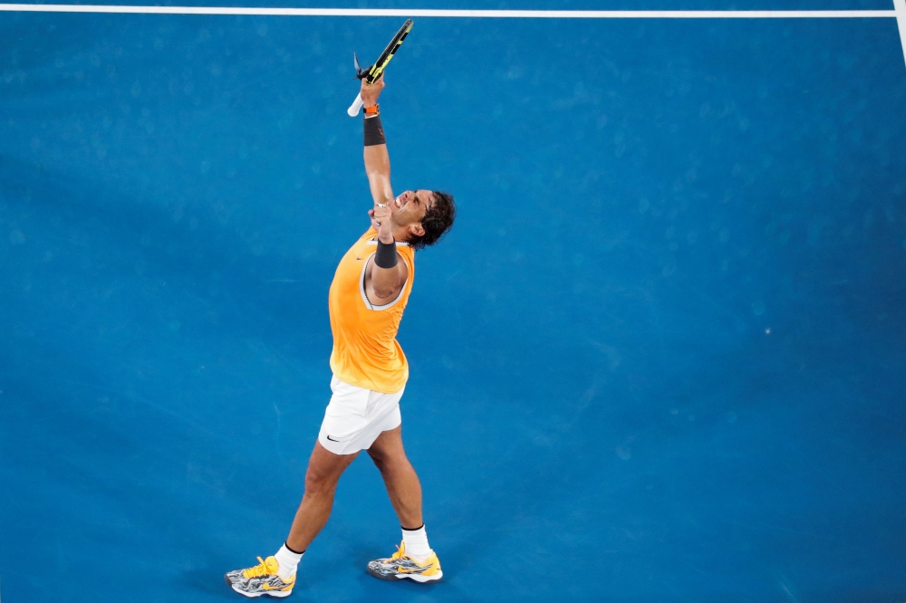 Spain's Rafael Nadal celebrates his victory against Greece's Stefanos Tsitsipas during their men's singles semi-final match on day 11 of the Australian Open tennis tournament in Melbourne on January 24, 2019.  AFP / DAVID GRAY 