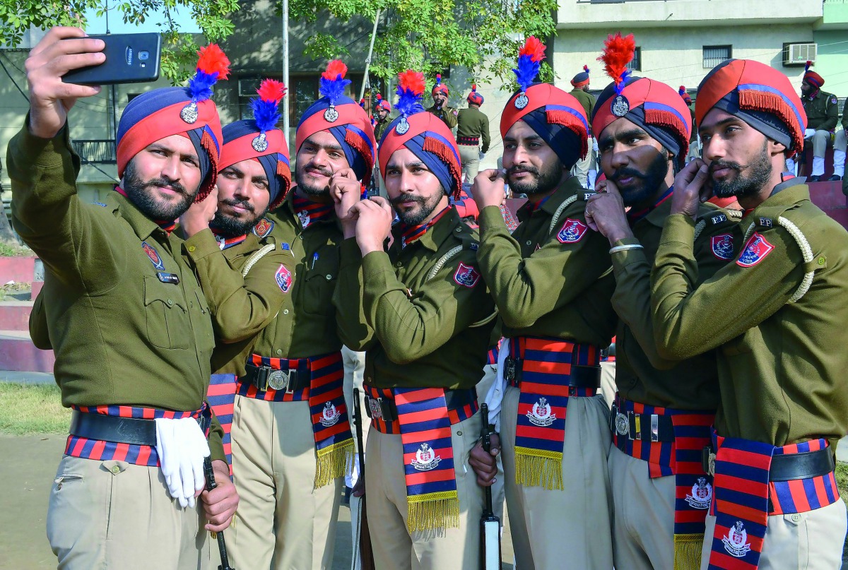 Indian Punjab police personnel take selfies during a full dress rehearsal for the upcoming 70th Republic Day parade in Amritsar on January 24, 2019. India will be celebrating its 70th Republic Day on January 26. AFP / Narinder Nanu
