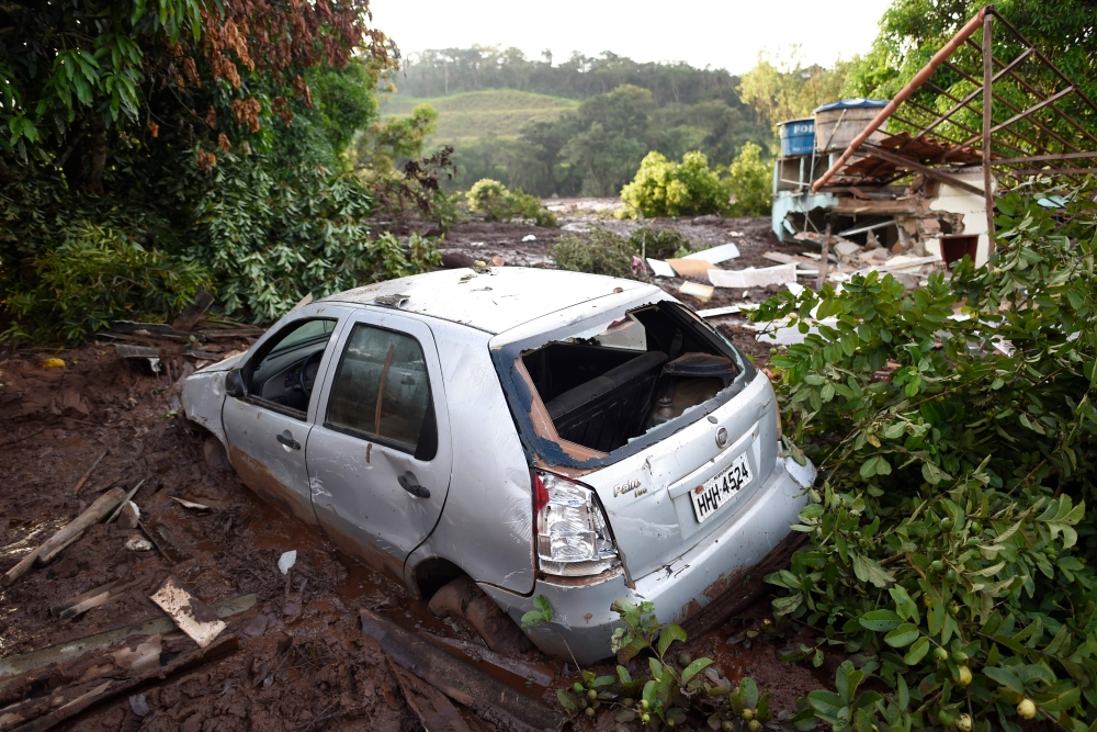 The wrackages of a car and house are seen amid the mud a day after the collapse of a dam at an iron-ore mine belonging to Brazil's giant mining company Vale, near the town of Brumadinho in the state of Minas Gerias in southeastern Brazil, on January 26, 2
