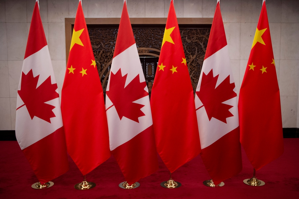FILE PHOTO: Picture of Canadian and Chinese flags taken prior to the meeting with Canada's Prime Minister Justin Trudeau and China's President Xi Jinping at the Diaoyutai State Guesthouse on December 5, 2017, in Beijing. Fred Dufour/Pool via REUTERS/File 