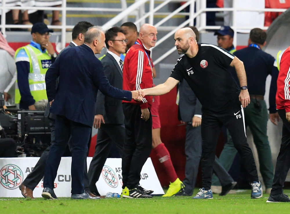 Qatar coach Felix Sanchez Bas shakes hands with United Arab Emirates coach Alberto Zaccheroni at the end of the match, January 29, 2019. REUTERS/Thaier Al-Sudani
