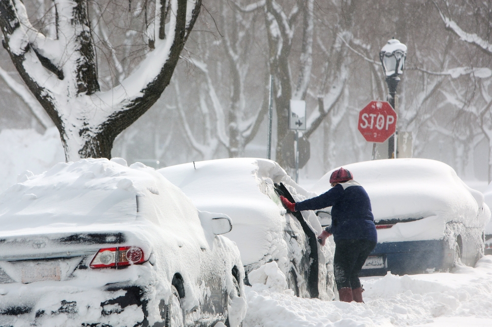 Woman clears a car in the snow during a winter storm in Buffalo, New York, U.S., January 31, 2019. (REUTERS/Lindsay DeDario)