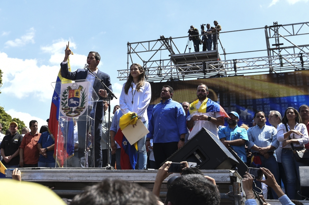 Opposition leader Juan Guaido (L) gestures next to his wife Fabiana Rosales as he delivers a speech before thousands of supporters, in Caracas on February 2, 2019. AFP / Juan Barreto 