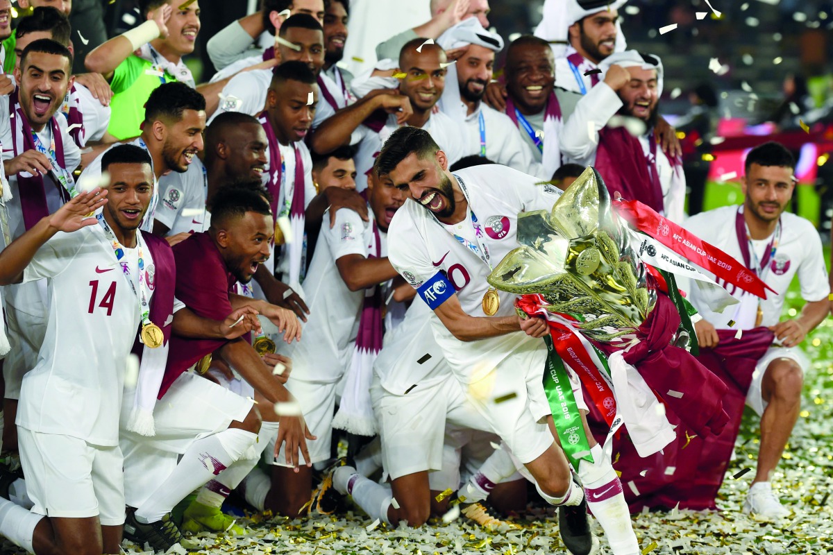 Qatar’s captain Hassan Al Haydos (centre) raises the trophy as he celebrates their win during the AFC Asian Cup final against Japan held at the Mohammed Bin Zayed Stadium in Abu Dhabi on February 1.