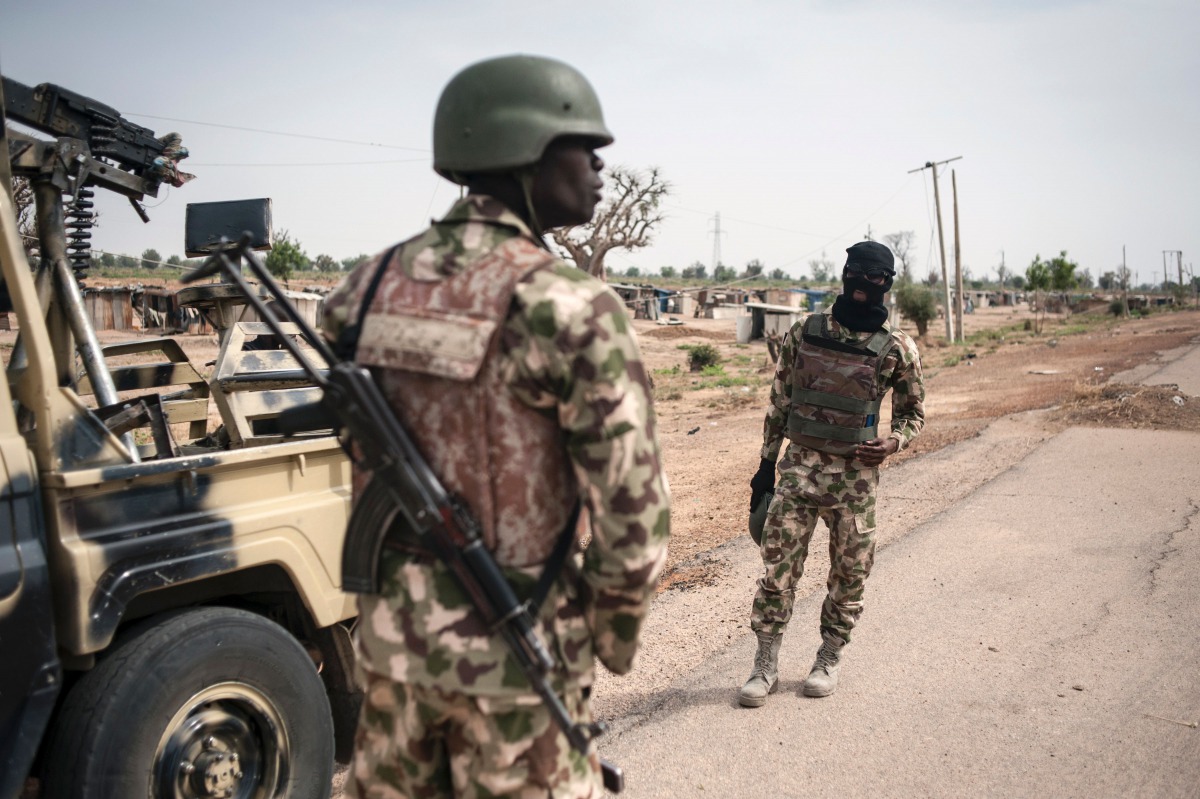 FILE PHOTO: Soldiers of the 7th Division of the Nigerian Army stand by the road in Damboa Borno State, northeast Nigeria on March 25, 2016. AFP/Stefan Heunis 